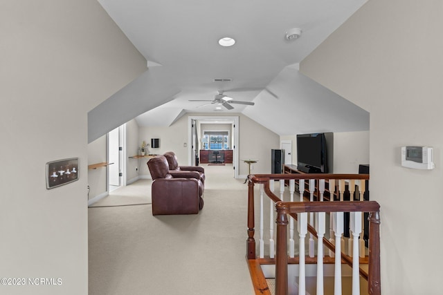 additional living space featuring light colored carpet, vaulted ceiling, and ceiling fan