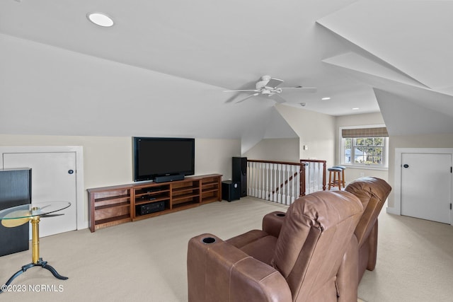 living room featuring light colored carpet, vaulted ceiling, and ceiling fan