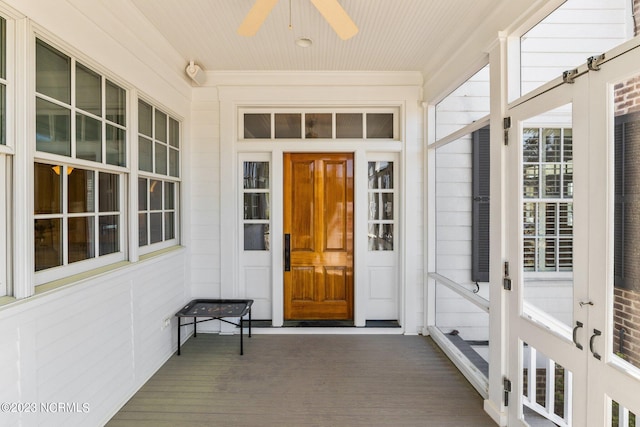 property entrance with ceiling fan and a porch