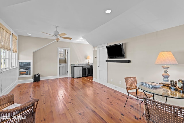 interior space featuring ceiling fan, light wood-type flooring, and vaulted ceiling