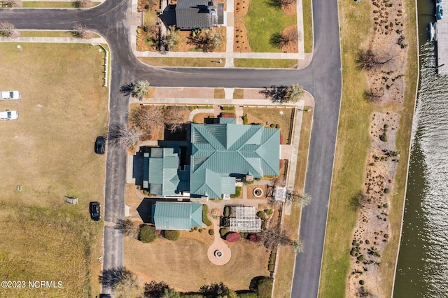 birds eye view of property with a water view