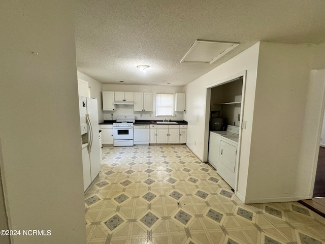 kitchen with white appliances, sink, light tile floors, white cabinets, and washer and clothes dryer