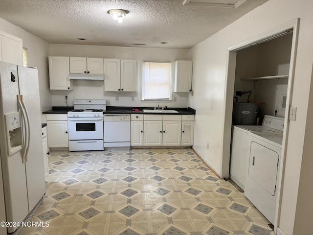 kitchen with sink, white appliances, and white cabinetry