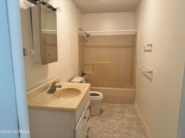 full bathroom with tile floors, washtub / shower combination, a textured ceiling, toilet, and vanity with extensive cabinet space