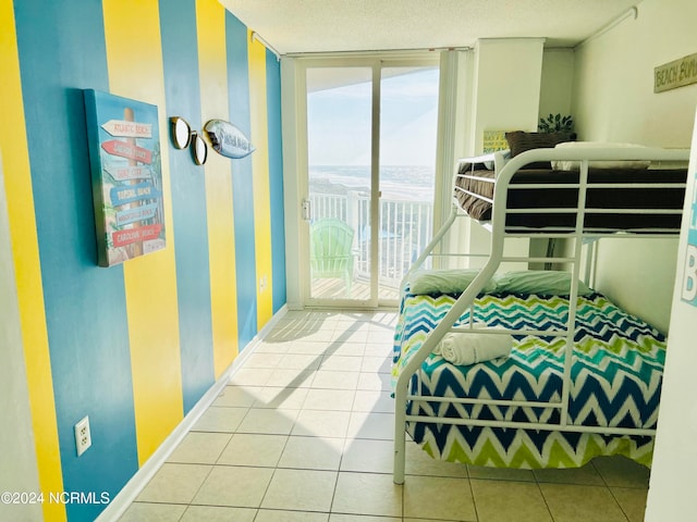 tiled bedroom with access to outside and a textured ceiling