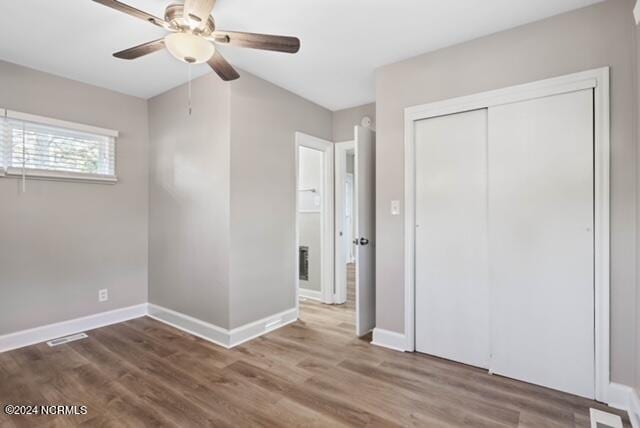 unfurnished bedroom featuring a closet, ceiling fan, and dark hardwood / wood-style flooring