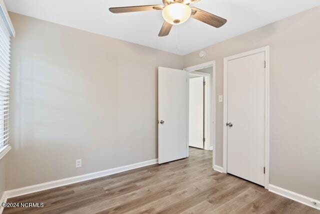 unfurnished room with ceiling fan and light hardwood / wood-style flooring