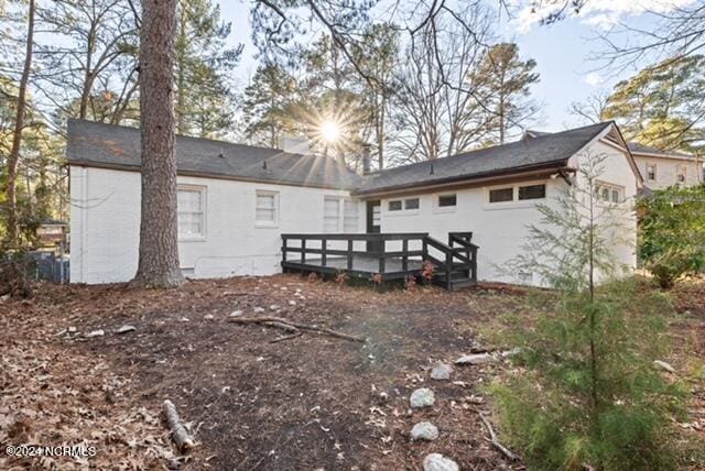 rear view of property featuring a deck