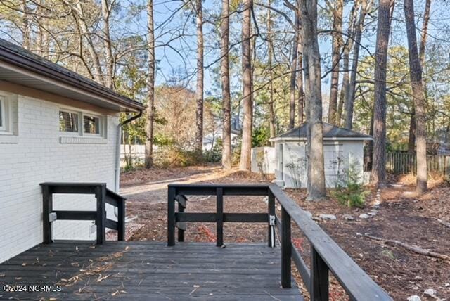 wooden terrace with a storage shed