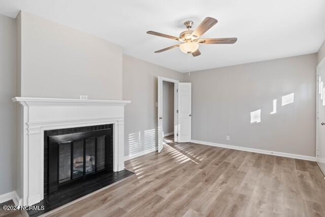 unfurnished living room featuring ceiling fan and light hardwood / wood-style floors