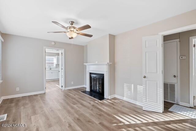 unfurnished living room with hardwood / wood-style floors and ceiling fan