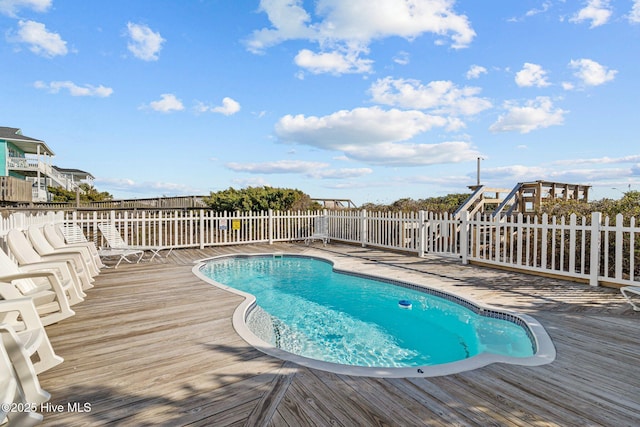 view of swimming pool with a deck