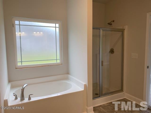 bathroom with separate shower and tub and a wealth of natural light