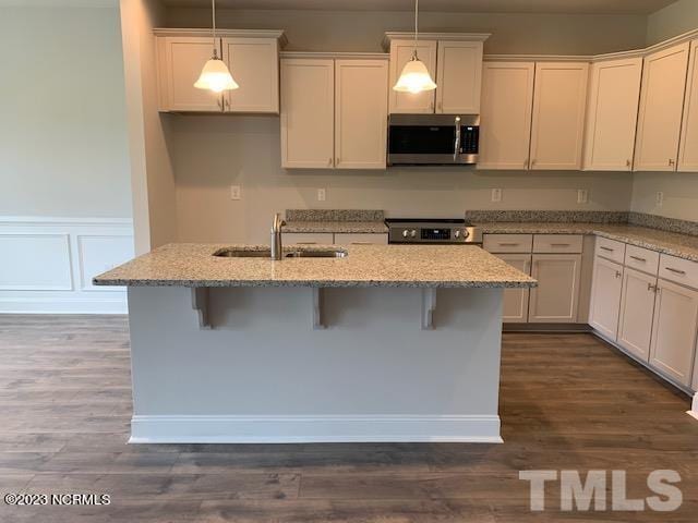 kitchen featuring dark hardwood / wood-style floors, sink, pendant lighting, and range