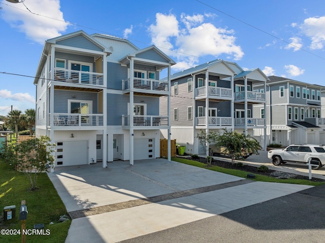 view of property featuring a balcony and a garage