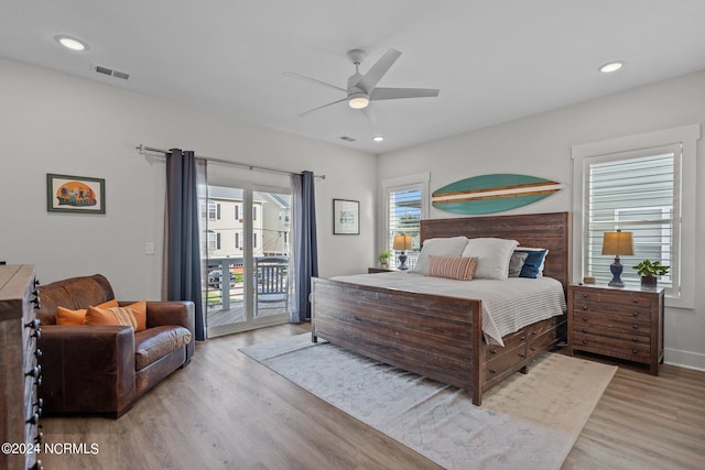 bedroom featuring ceiling fan, multiple windows, access to exterior, and light hardwood / wood-style flooring