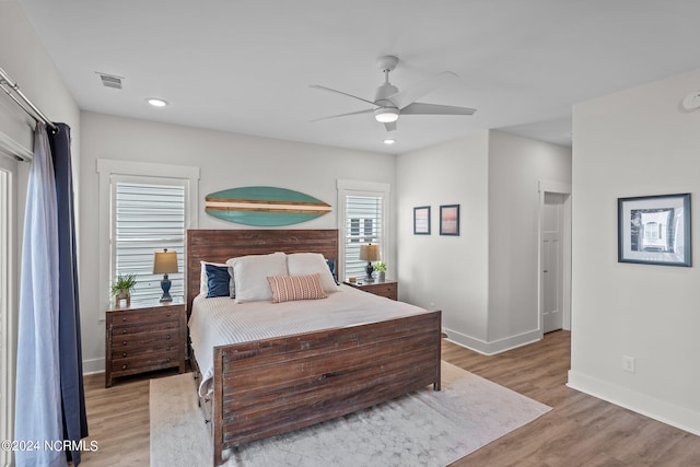 bedroom with light hardwood / wood-style flooring and ceiling fan