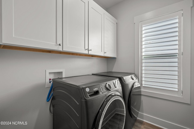 clothes washing area featuring cabinets, dark wood-type flooring, separate washer and dryer, and washer hookup