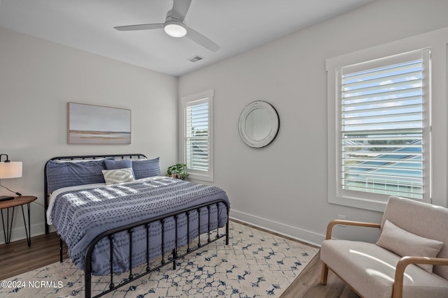 bedroom with light hardwood / wood-style floors and ceiling fan