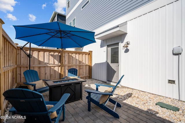 wooden terrace with a patio area