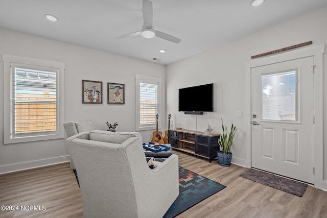 living room with ceiling fan and light hardwood / wood-style floors