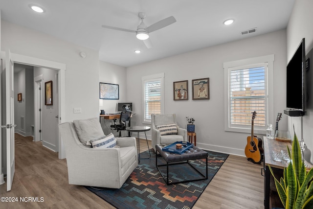 living room with ceiling fan and wood-type flooring