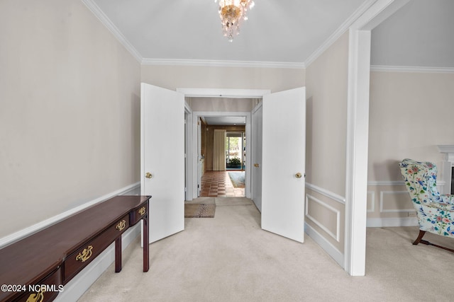 hall with light colored carpet, an inviting chandelier, and crown molding