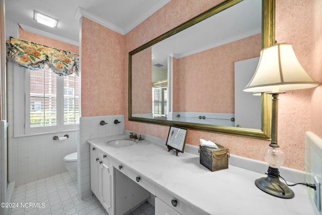 bathroom featuring oversized vanity, toilet, tile flooring, tile walls, and ornamental molding