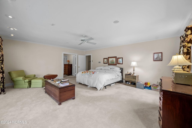 bedroom featuring light carpet, ceiling fan, and crown molding