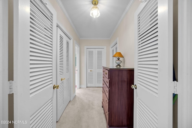 hallway with crown molding and light colored carpet