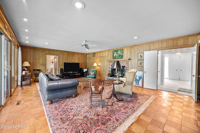 living room with wood walls and ceiling fan