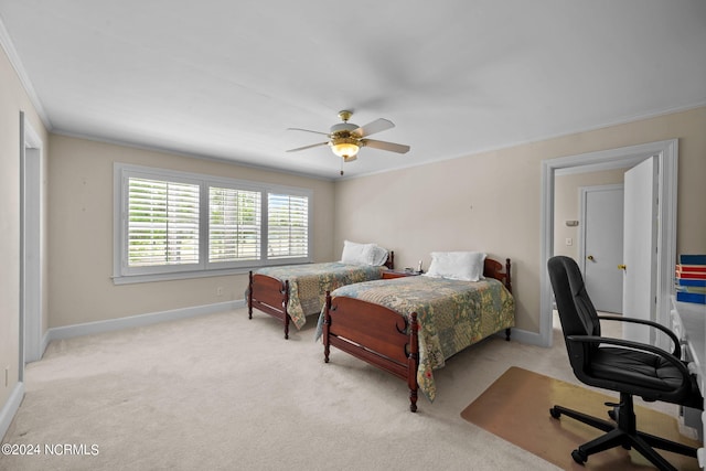 carpeted bedroom with ceiling fan and ornamental molding