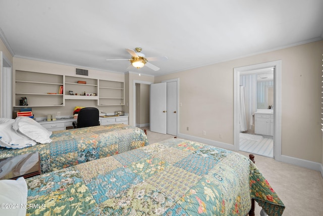 carpeted bedroom featuring ensuite bath, ceiling fan, and crown molding