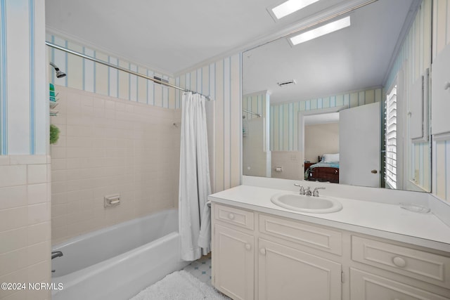 bathroom with vanity with extensive cabinet space, tile flooring, and shower / tub combo