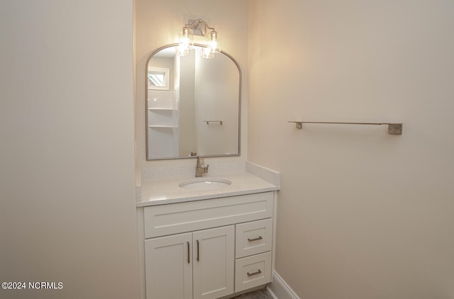 bathroom with vanity and baseboards