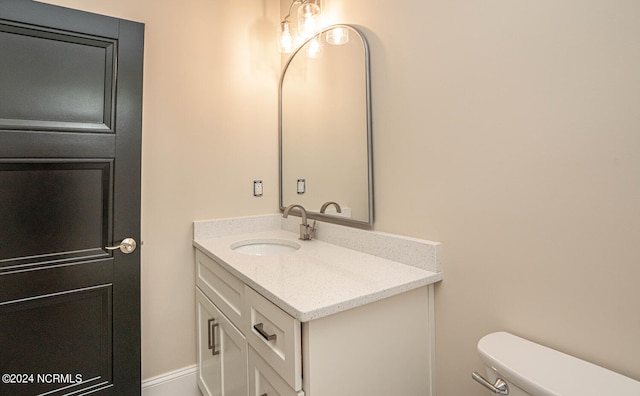 bathroom with toilet and vanity