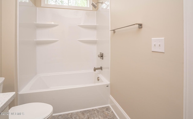 full bath with  shower combination, toilet, and baseboards