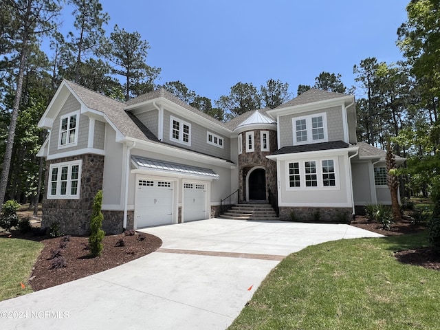 shingle-style home with an attached garage, stone siding, a shingled roof, and concrete driveway