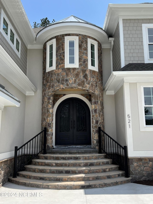 entrance to property featuring stucco siding