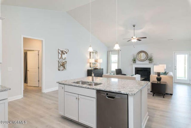 kitchen featuring lofted ceiling, light hardwood / wood-style flooring, white cabinetry, and stainless steel dishwasher