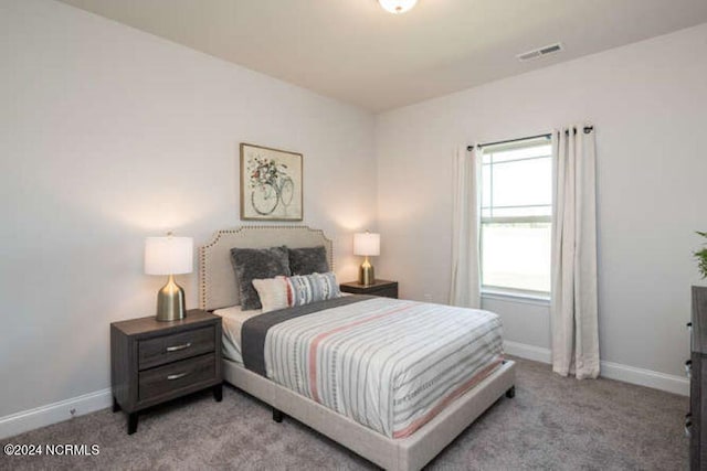 bedroom with light colored carpet