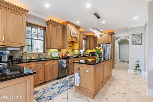 kitchen with pendant lighting, tasteful backsplash, a center island, and appliances with stainless steel finishes