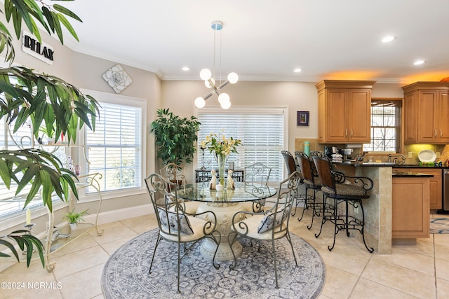 tiled dining space with an inviting chandelier and ornamental molding