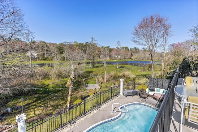 view of pool with a water view and a patio area