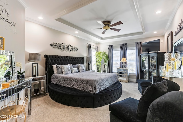 bedroom featuring light carpet, ceiling fan, multiple windows, and a raised ceiling