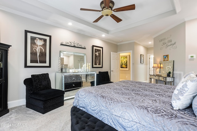 bedroom with ceiling fan, a raised ceiling, light colored carpet, and ornamental molding