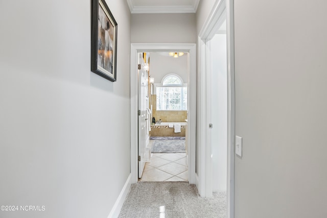 hallway featuring ornamental molding and light carpet