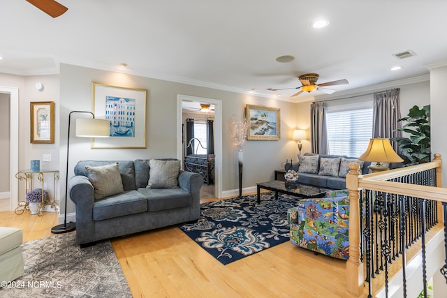 living room with crown molding, light hardwood / wood-style floors, and ceiling fan