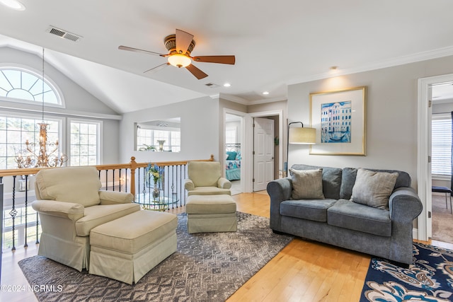 living room featuring ceiling fan, lofted ceiling, crown molding, and wood-type flooring