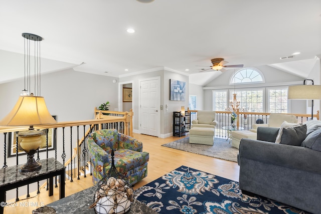 living room with light hardwood / wood-style flooring, crown molding, ceiling fan with notable chandelier, and vaulted ceiling